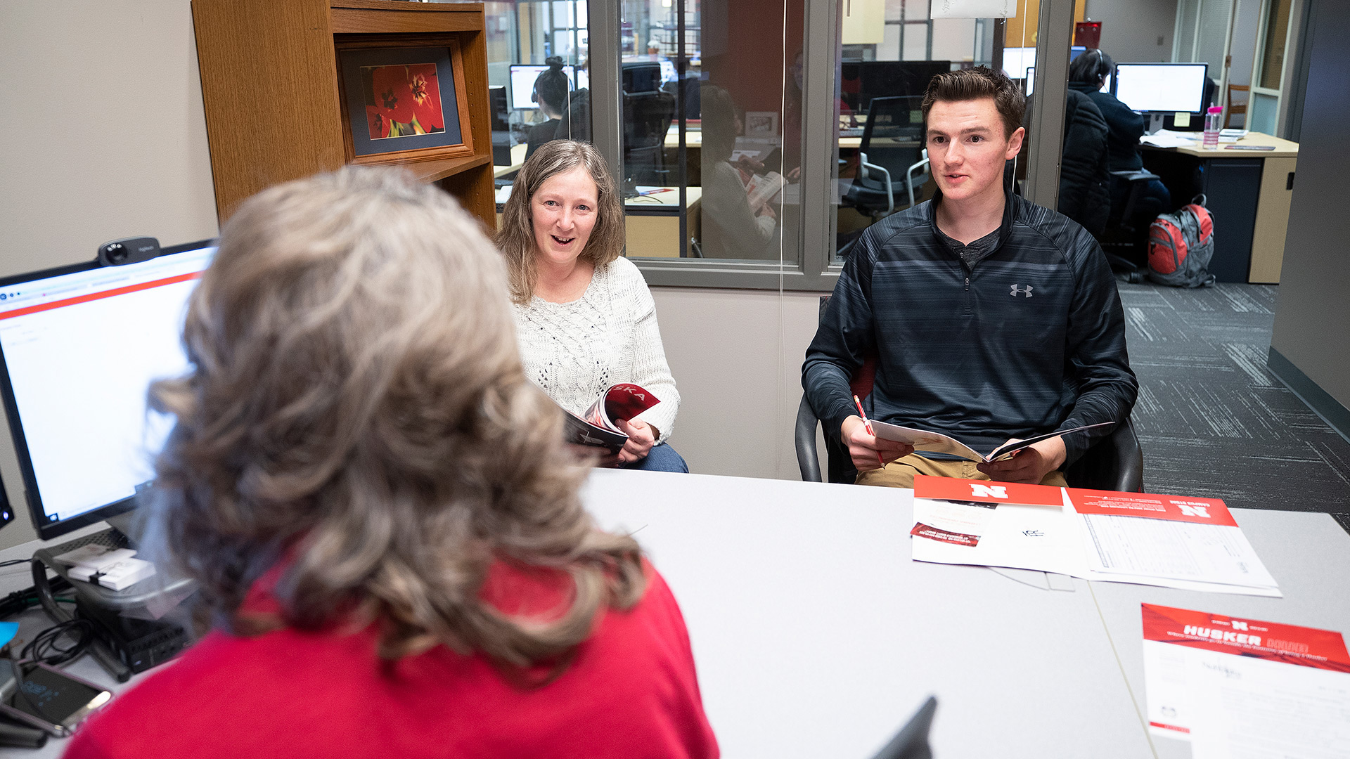 A student and his parent talking to an advisor