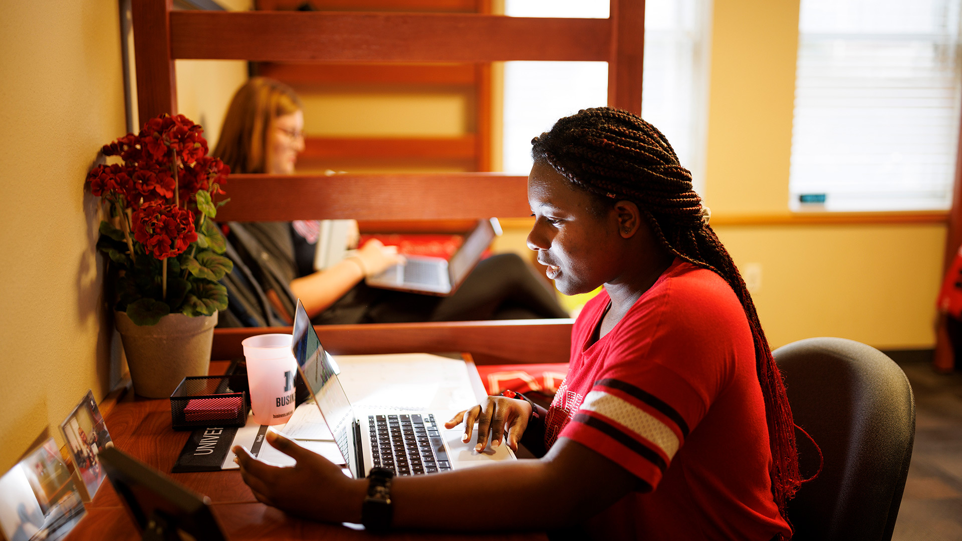 Student working on a computer in her dorm