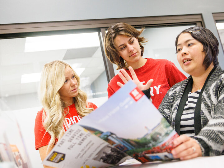 An advisor discusses programs with two prospective students